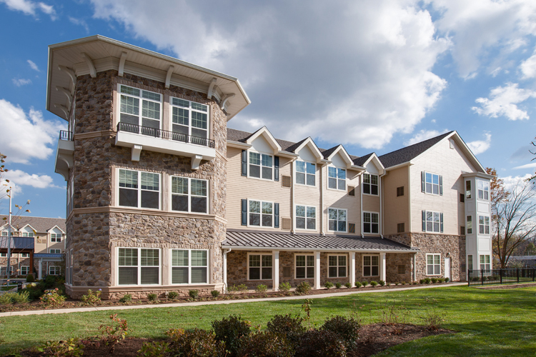 Exterior view of a multi-story building of Solana senior living community on a sunny day.